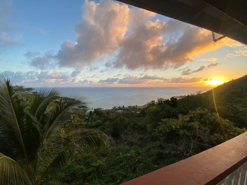 a view of the ocean at sunset from a balcony at LE BLANC HIDEAWAY in Laborie