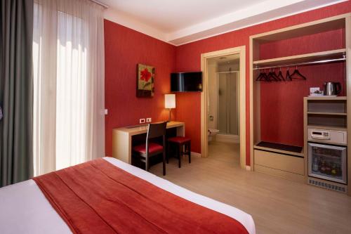 a hotel room with a bed and a desk at Best Western Porto Antico in Genova