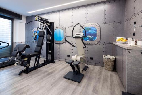 a fitness room with a gym with two tread machines at Best Western Porto Antico in Genoa