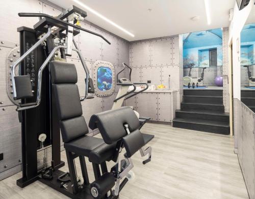 a gym with a chair in a room at Best Western Porto Antico in Genova