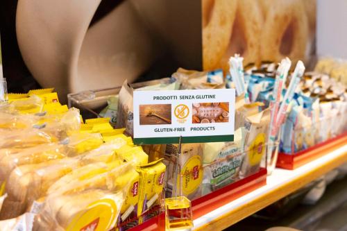 a store shelf with a display of different food items at Best Western Porto Antico in Genova