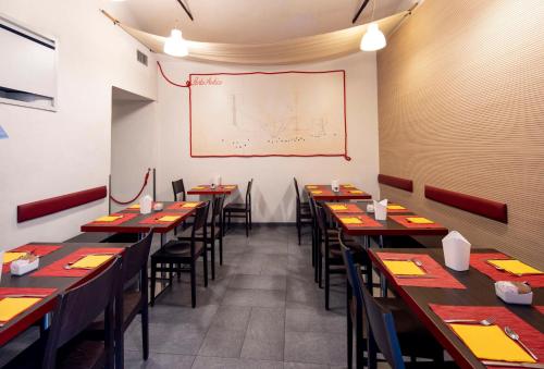 a dining room with tables and chairs and a whiteboard at Best Western Porto Antico in Genova