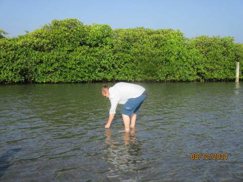 a man is standing in the water at Ralph recedency in Kochchikade