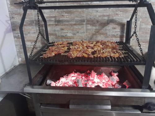 a grill with a bunch of food on it at Casa Quinta Santana in Melgar