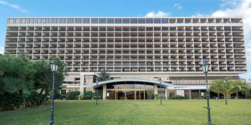 a large building with a lawn in front of it at Hilton Istanbul Bosphorus in Istanbul