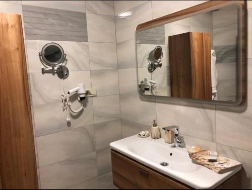 a bathroom with a sink and a mirror at Blue Pier Hotel in Kocaeli