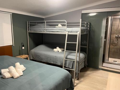 a bedroom with two bunk beds and a chair at Sun house - Near Sintra - Kitchen - Pool in Sintra