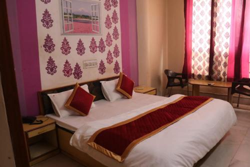 a bedroom with a large bed in a room at Hotel Kirti Plaza in Chittaurgarh