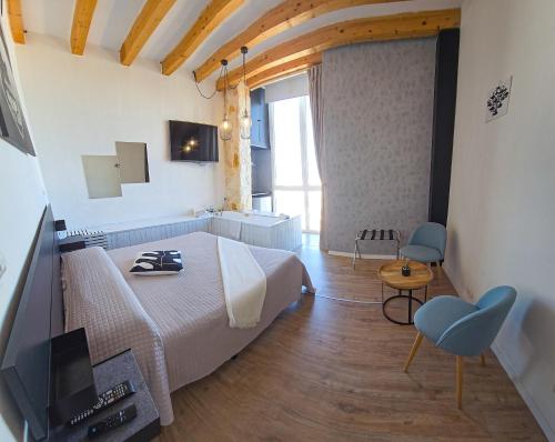 um quarto com uma cama e uma televisão num quarto em B&B 106 Maison de Charme em Mola di Bari
