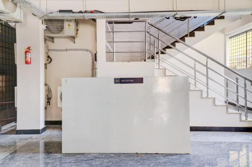 an empty room with stairs in a building at OYO Hotel Elite Lifestyle Red Rose Near 7d Voyage in Bangalore