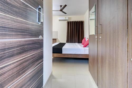 a door leading to a bedroom with a bed at OYO Hotel Elite Lifestyle Red Rose Near 7d Voyage in Bangalore