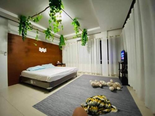 a bedroom with a bed and some stuffed animals on the floor at Seaheart Guesthouse in Dauis