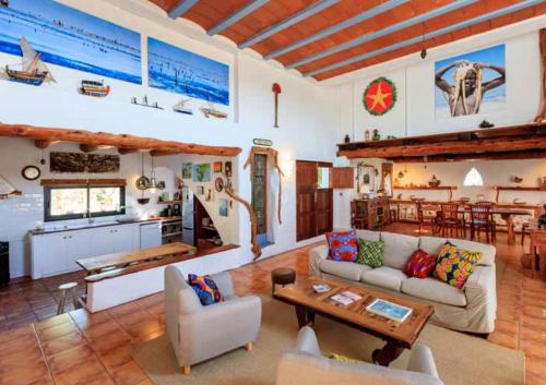a living room with a couch and a table at Can Piedrópolis in Cala Saona