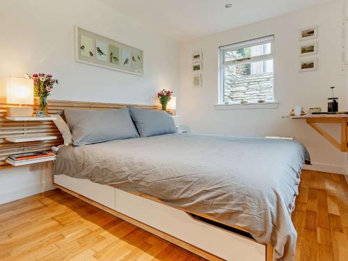 a bedroom with a large bed with a window at 2 Bed in Tarbert 85374 in Tarbert