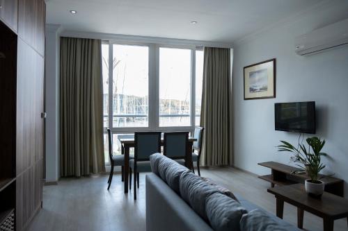 a living room with a couch and a table at Kordon Apartment in Fethiye