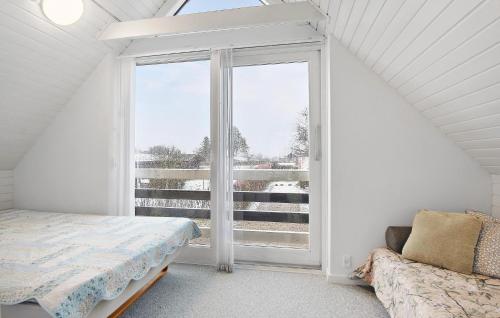a bedroom with a bed and a large window at Gorgeous Home In Assens With Kitchen in Assens