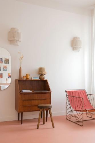 a chair and a dresser in a room with a stool at SLO Hostel Nice in Nice