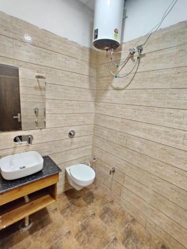 a bathroom with a toilet and a sink at HOTEL D.S in Amritsar