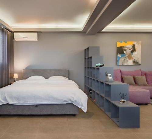 a bedroom with a bed and a couch at Boutique Apartment in Athens Center in Athens