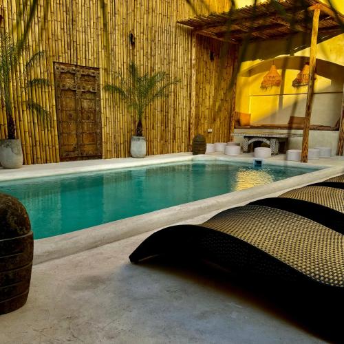 a large swimming pool in a room with at L’Oasis Nanai in Patong Beach