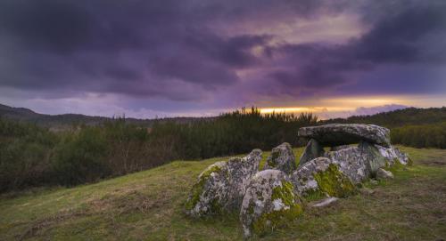 a stone bench on top of a grassy hill at Quinta do Fontelo in Vouzela