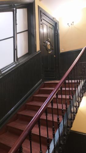 a set of stairs with a black door at Pensión Manoli in Bilbao