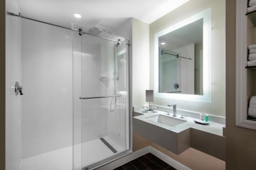 a bathroom with a shower and a sink at The Westin Dallas Stonebriar Golf Resort & Spa in Frisco