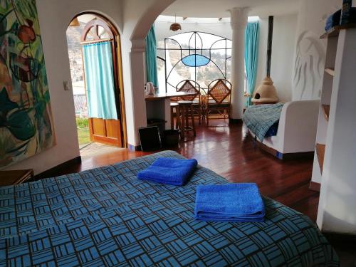a bedroom with two blue pillows on a bed at Suites Sultan in Copacabana