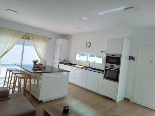 a kitchen with white cabinets and a counter top at La Catumbela in Tuineje
