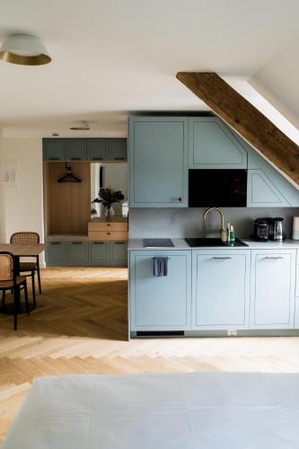 a kitchen with white cabinets and a dining room at Bob W Peterhof in Freising