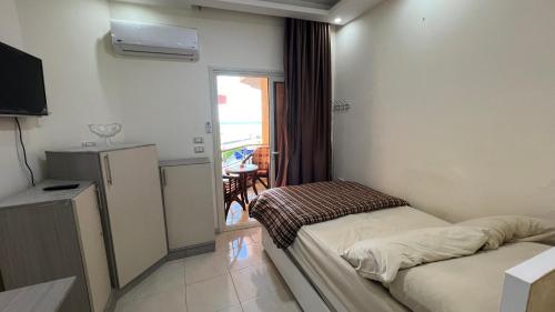 A bed or beds in a room at Casablanca beach resort, first line with private beach and swimming pools,