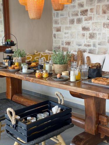 a table with a buffet with food on it at The Sand Villa in Agios Nikolaos