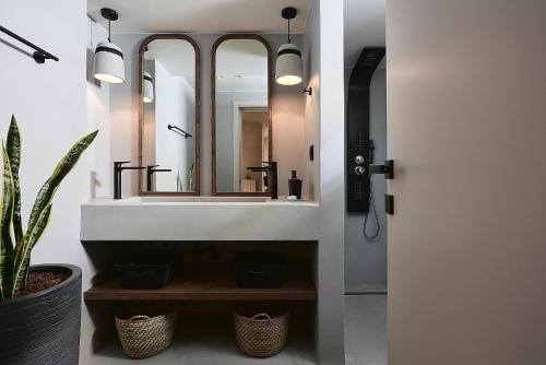 a bathroom with a sink and a mirror at The Sand Villa in Agios Nikolaos