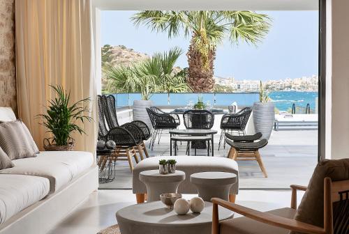 a living room with a view of the ocean at The Sand Villa in Agios Nikolaos
