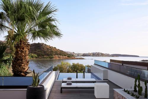 a house with a view of the water at The Sand Villa in Agios Nikolaos
