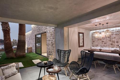 a living room with a table and chairs at The Sand Villa in Agios Nikolaos