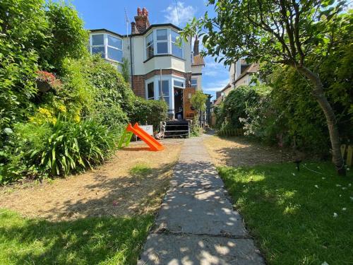 a sidewalk in front of a house with an orange object at Edwardian Villa by the sea-side in Walton-on-the-Naze