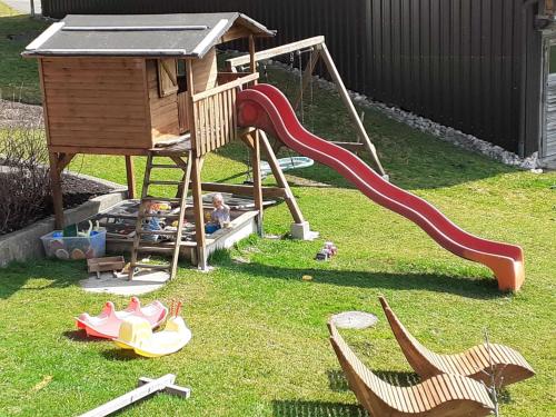 a child playing on a playground with a slide at Haus Peintner in Tannheim