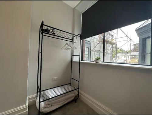 an empty room with a window and a iron shelf at Superior Stay, Sophia Gardens, City Centre and Stadium Sleeps 4 in Cardiff