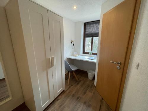 a bathroom with a sink and a toilet and a window at Avenue Das Gästehaus in Chemnitz