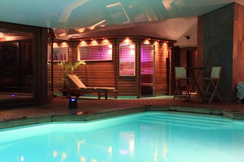 a swimming pool in a house with lights on it at Domaine de la Butte Ronde in La Boissière-École