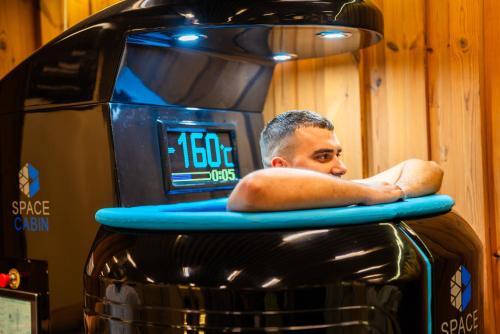 a man sitting on a surfboard on top of a truck at Lucky Bansko Aparthotel SPA & Relax in Bansko