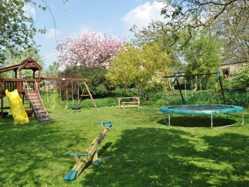 a park with a playground with a slide and swings at 2 bed property in Axminster BLOLO in Axminster