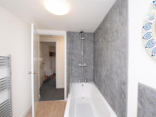 a bathroom with a bath tub and a shower at 2 bed in Brixham 75549 in Brixham