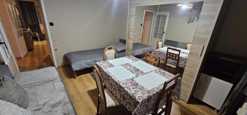 a room with two beds and a table and chairs at Apartament WIDOK 2 in Świebodzin