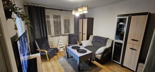 a living room with a couch and a table at Apartament WIDOK 2 in Świebodzin