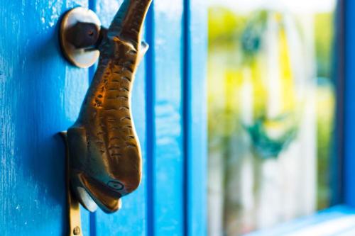 a close up of a door handle on a blue door at Tan Y Bryn in Llanrhystyd