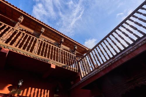a building with wooden balconies on top of it at Kaladwas Lal Haveli - A Heritage Boutique Hotel in Udaipur