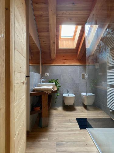 a bathroom with a sink and a toilet and a window at Baita La Pesse - Ad un passo dalle stelle in Nus