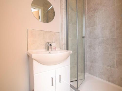 a bathroom with a sink and a shower at 2 Bed in Ilfracombe 66328 in Ilfracombe